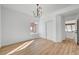 Bright bedroom features light wood floors, chandelier and closet with sliding doors at 8941 Diamond Falls Dr, Las Vegas, NV 89117