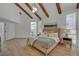 Main bedroom with wood beams, large windows, and light wood floors at 8941 Diamond Falls Dr, Las Vegas, NV 89117