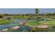 Picturesque view of a golf course with lush greenery, serene water features, and clear blue skies at 8941 Diamond Falls Dr, Las Vegas, NV 89117