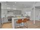 Bright kitchen features stainless steel appliances, marble countertops, and an island with bar seating at 8941 Diamond Falls Dr, Las Vegas, NV 89117