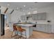 Contemporary kitchen featuring an island with bar seating, stainless steel appliances, and wood floors at 8941 Diamond Falls Dr, Las Vegas, NV 89117