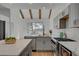 Spacious kitchen boasting gray cabinets, quartz countertops, and a view to the backyard at 8941 Diamond Falls Dr, Las Vegas, NV 89117