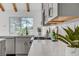 Modern kitchen with gray cabinets, quartz countertops, and a pool view at 8941 Diamond Falls Dr, Las Vegas, NV 89117