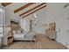 Relaxing main bedroom with exposed beams, modern decor, and a neutral color palette at 8941 Diamond Falls Dr, Las Vegas, NV 89117