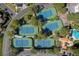 Aerial view of four well-maintained tennis courts in a beautiful community setting with lush landscaping at 8941 Diamond Falls Dr, Las Vegas, NV 89117