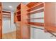 This walk-in closet features custom wood shelving and ample storage space for organizing clothes and accessories at 8941 Diamond Falls Dr, Las Vegas, NV 89117