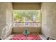 Cozy balcony with a red rug, peaceful view, and access doors at 904 Domnus Ln # 201, Las Vegas, NV 89144