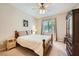 Cozy bedroom with a ceiling fan, neutral walls, and natural light from the window at 904 Domnus Ln # 201, Las Vegas, NV 89144