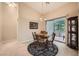 Cozy dining area with a round table, chandelier, and sliding glass door to the outdoors at 904 Domnus Ln # 201, Las Vegas, NV 89144