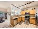 Well-lit kitchen with stainless steel appliances, granite countertops, and modern lighting fixtures at 904 Domnus Ln # 201, Las Vegas, NV 89144