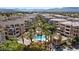 Aerial view of community with pool and mountains at 9201 Las Manaitas Ave # 302, Las Vegas, NV 89144