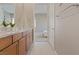 Clean bathroom with double vanity and view to bedroom at 9201 Las Manaitas Ave # 302, Las Vegas, NV 89144