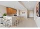 Modern wet bar with wood cabinetry and a quartz countertop at 9201 Las Manaitas Ave # 302, Las Vegas, NV 89144