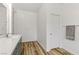 Modern bathroom with gray vanity, white countertop, and wood-look floors at 9281 Albus Hills Ave, Las Vegas, NV 89143