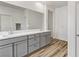 Elegant bathroom with double sinks, gray cabinets, and large mirror at 9281 Albus Hills Ave, Las Vegas, NV 89143