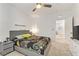 Bedroom with gray bed, ceiling fan, and access to another room at 9281 Albus Hills Ave, Las Vegas, NV 89143