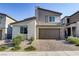 Two-story home with brown garage door and landscaped front yard at 9281 Albus Hills Ave, Las Vegas, NV 89143