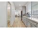 Hallway view of kitchen and adjacent bathroom at 9281 Albus Hills Ave, Las Vegas, NV 89143