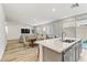 Open concept kitchen with island and stainless steel appliances, view into living area at 9281 Albus Hills Ave, Las Vegas, NV 89143