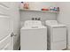 Laundry room with washer, dryer, and overhead shelving at 9281 Albus Hills Ave, Las Vegas, NV 89143