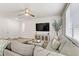 Spacious living room featuring a large sectional sofa, TV, and ample natural light at 9281 Albus Hills Ave, Las Vegas, NV 89143