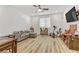 Open living area with gray sectional sofa, exercise bike, and hardwood flooring at 9281 Albus Hills Ave, Las Vegas, NV 89143