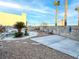 Landscaped backyard featuring a rock waterfall feature, gravel area, and block wall at 9290 Cool Creek Ave, Las Vegas, NV 89147