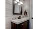 Updated bathroom with white vanity, wood-look tile, and barn wood accent wall at 9290 Cool Creek Ave, Las Vegas, NV 89147