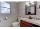 Updated bathroom with white vanity, wood-look tile, and barn wood accent wall at 9290 Cool Creek Ave, Las Vegas, NV 89147