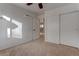 Bedroom with neutral carpet, a closet with sliding doors, and a view of the staircase at 9290 Cool Creek Ave, Las Vegas, NV 89147