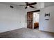 A spacious bedroom has a sliding barn door to the attached bathroom and a ceiling fan at 9290 Cool Creek Ave, Las Vegas, NV 89147