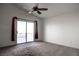 A bright bedroom has a sliding glass door to a private balcony, a ceiling fan, and neutral carpeting at 9290 Cool Creek Ave, Las Vegas, NV 89147