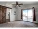 A spacious bedroom with a sliding glass door to a private balcony and a ceiling fan at 9290 Cool Creek Ave, Las Vegas, NV 89147