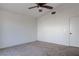 A neutral bedroom has a ceiling fan, carpet, and white walls at 9290 Cool Creek Ave, Las Vegas, NV 89147