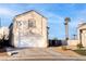 Two-story house with attached garage and desert landscaping at 9290 Cool Creek Ave, Las Vegas, NV 89147