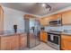 Modern kitchen with stainless steel appliances and wood cabinets at 9290 Cool Creek Ave, Las Vegas, NV 89147