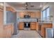 Modern kitchen with stainless steel appliances and wood cabinets at 9290 Cool Creek Ave, Las Vegas, NV 89147