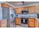 Modern kitchen with stainless steel appliances and wood cabinets at 9290 Cool Creek Ave, Las Vegas, NV 89147