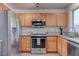 Modern kitchen with stainless steel appliances and wood cabinets at 9290 Cool Creek Ave, Las Vegas, NV 89147