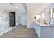 Spa-like bathroom with marble shower, double vanity, and modern lighting at 9541 Summersweet Ct, Las Vegas, NV 89123