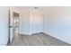 Bright bedroom with wood-look floors and access to hallway at 9541 Summersweet Ct, Las Vegas, NV 89123