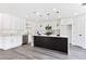 Modern kitchen with white cabinets, marble island, and gold accents at 9541 Summersweet Ct, Las Vegas, NV 89123