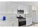 Modern kitchen with stainless steel appliances and white cabinets at 9541 Summersweet Ct, Las Vegas, NV 89123