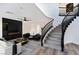 Living room with fireplace and modern staircase at 9541 Summersweet Ct, Las Vegas, NV 89123