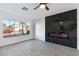 Living room with fireplace and large window overlooking the street at 9541 Summersweet Ct, Las Vegas, NV 89123