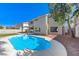 Relaxing kidney-shaped pool surrounded by a landscaped backyard at 9541 Summersweet Ct, Las Vegas, NV 89123