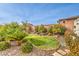 Landscaped backyard with lush lawn and mature shrubs at 9705 Yellow Shadow Ave, Las Vegas, NV 89149