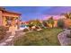 Landscaped backyard with grass and stone pathways at 9705 Yellow Shadow Ave, Las Vegas, NV 89149