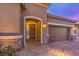 Attractive exterior with a two-car garage and stone accents at 9705 Yellow Shadow Ave, Las Vegas, NV 89149