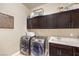 Convenient laundry room with washer, dryer, and ample storage at 9705 Yellow Shadow Ave, Las Vegas, NV 89149